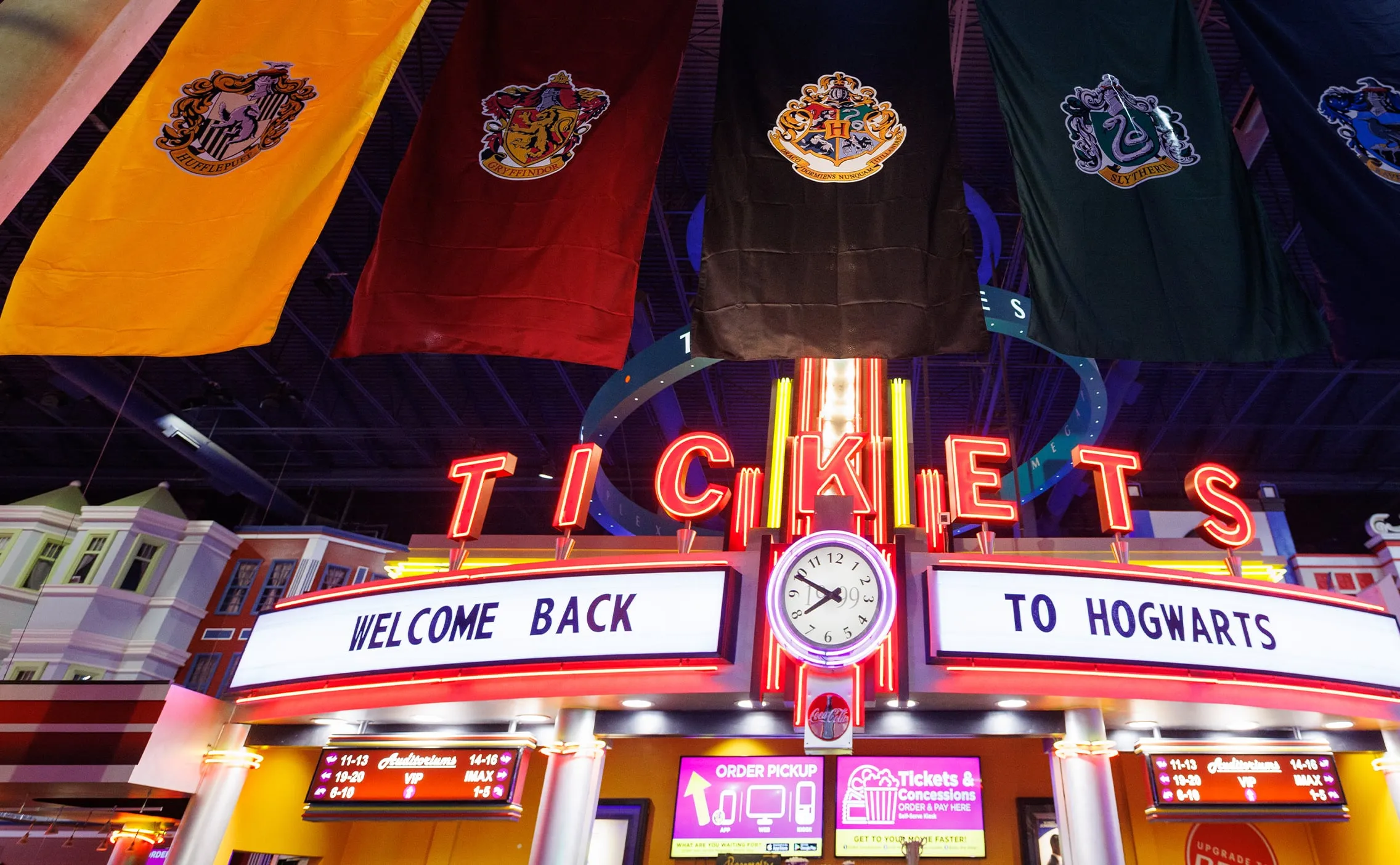 Ticket marquee reading Welcome Back to Hogwarts under house banners