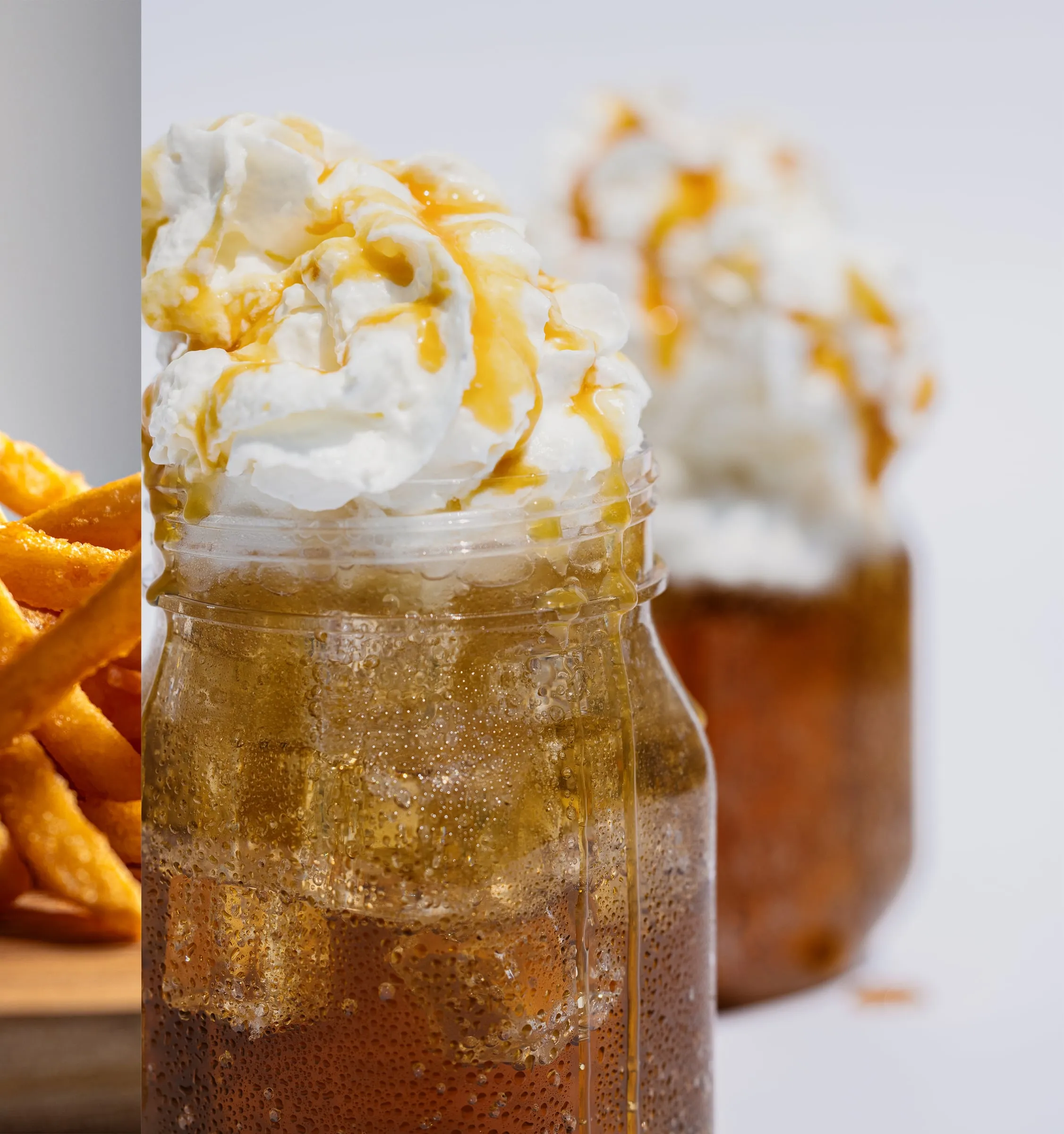 Root beer float in a mason jar topped with whipped cream and caramel