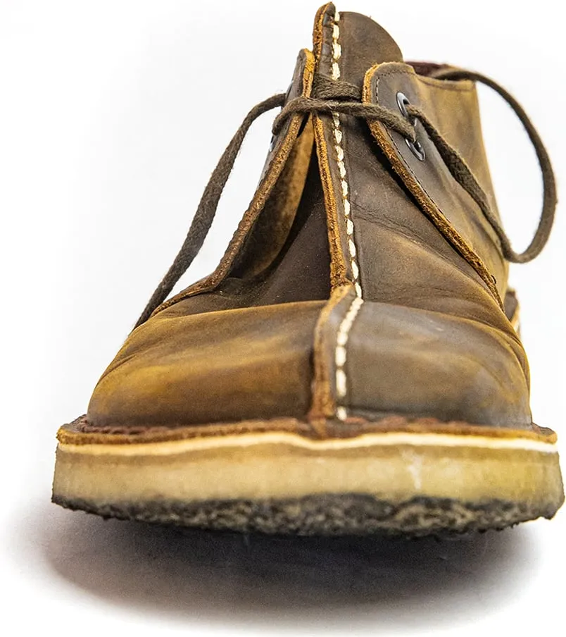 Worn leather desert boot, front view on white