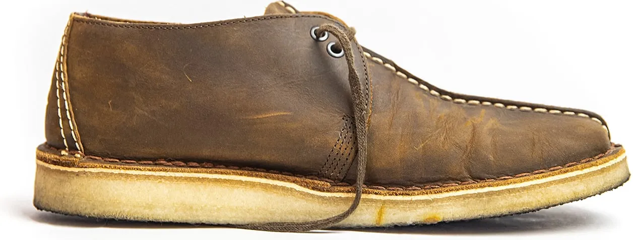 Worn leather desert boot, side view on white